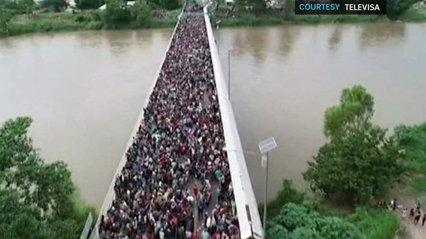 Drone footage shows thousands of migrants attempting to cross into Mexico.