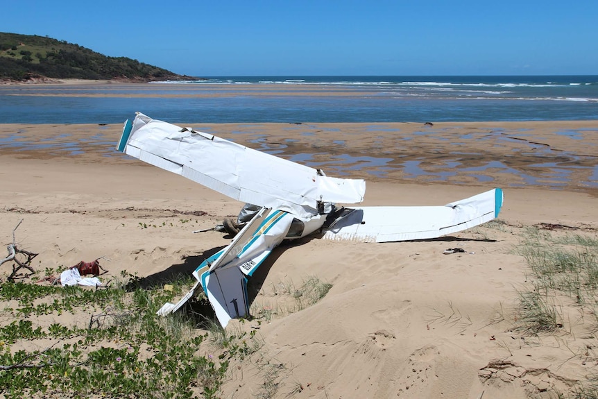 Twisted wreckage of the plane on the beach near Middle Island.