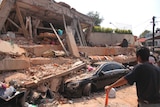 A car lays crushed under the collapsed Enrique Rebsamen school in after the Mexico City earthquake