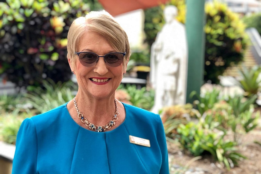 Principal Ann Rebgetz smiles as she stands in the grounds of of St James College in inner-Brisbane.