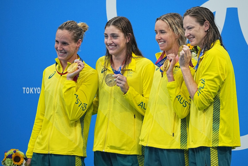 Australian 4x100m Olympic relay swimming team hold their medals and smile