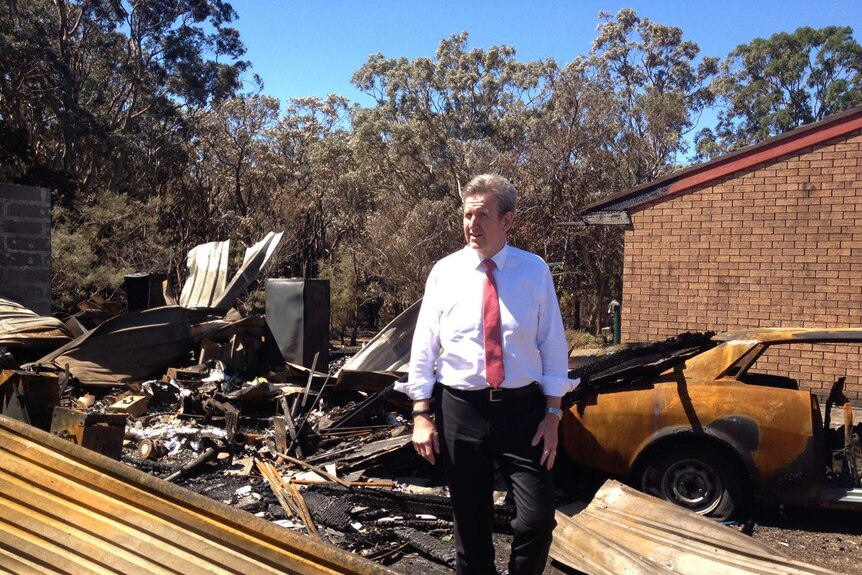 The NSW Premier, Barry O'Farrell inspects the fire damage at Salt Ash, Port Stephens earlier this month.