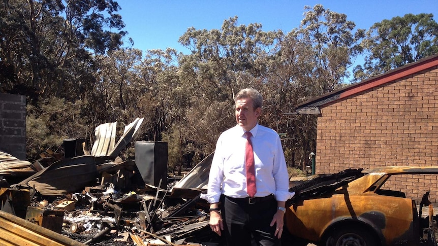 The NSW Premier, Barry O'Farrell inspects the fire damage at Salt Ash, Port Stephens earlier this month.