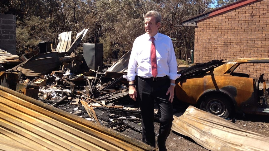 NSW Premier Barry O'Farrell inspects the damage caused by a fire at Salt Ash on Sunday.