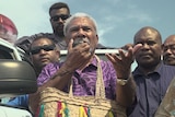 Former PNG prime minister Sir Mekere Morauta addresses supporters outside the tally room.