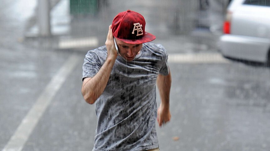 Melburnians get caught out in a sudden downpour of rain in the CBD.