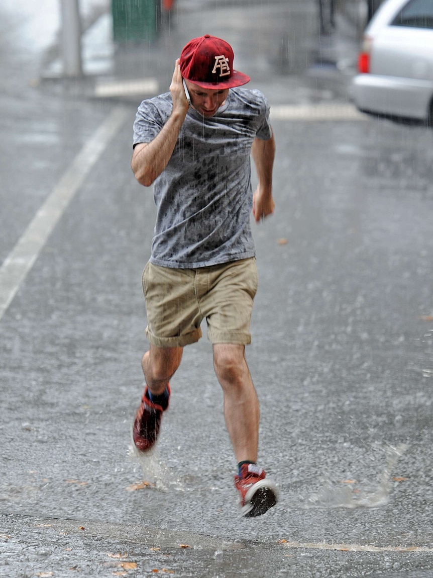 Melburnians get caught out in a sudden downpour of rain in the CBD.