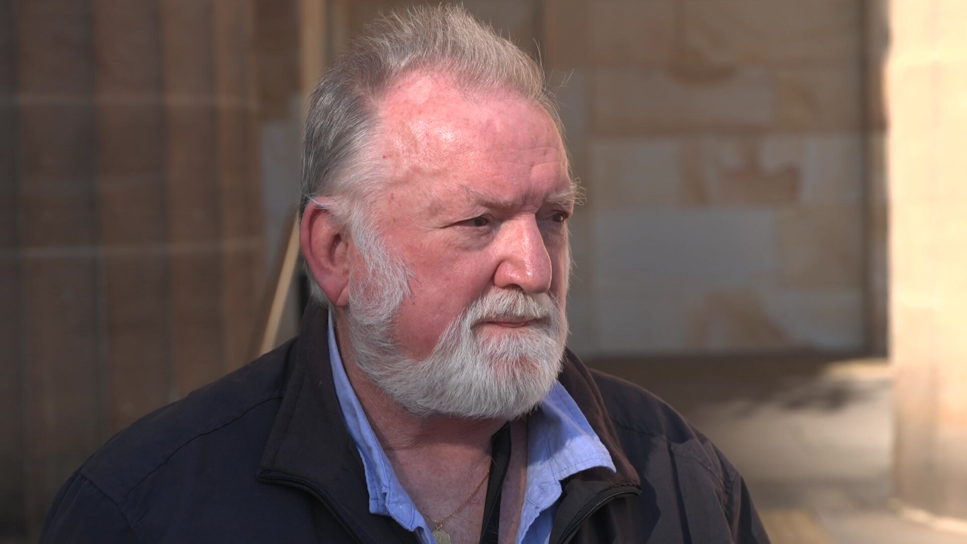 Man stands outside court speaking to the media