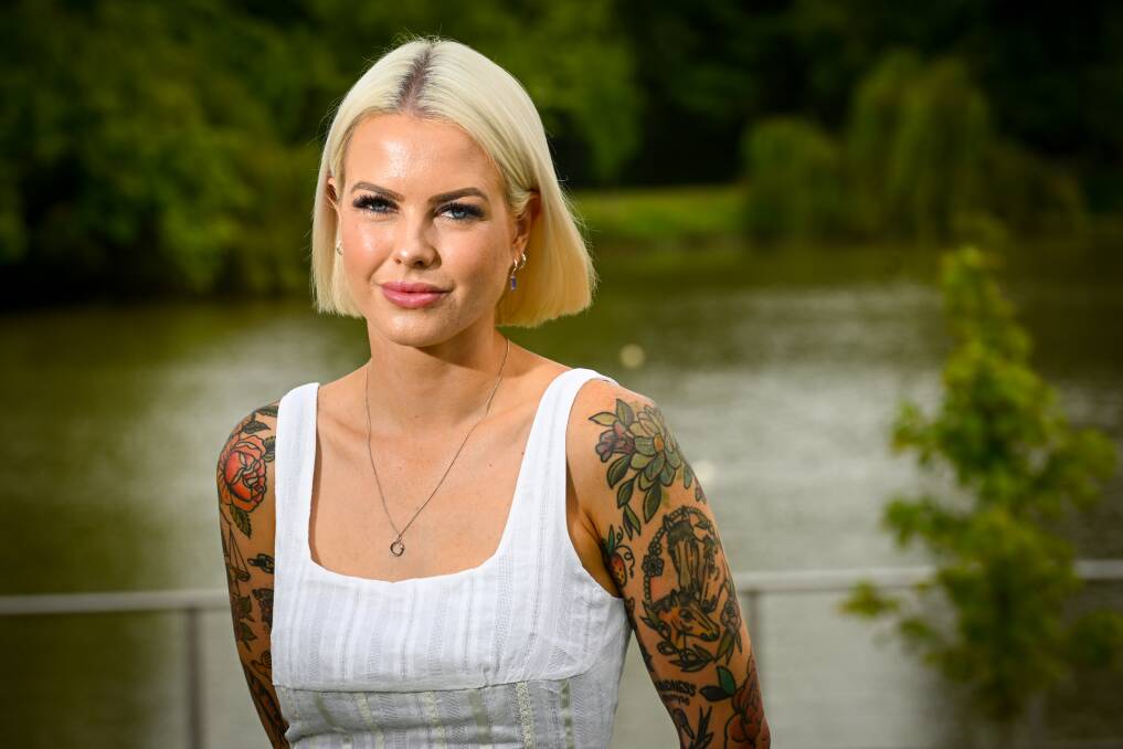 Georgie Purcell stands in front of a river.