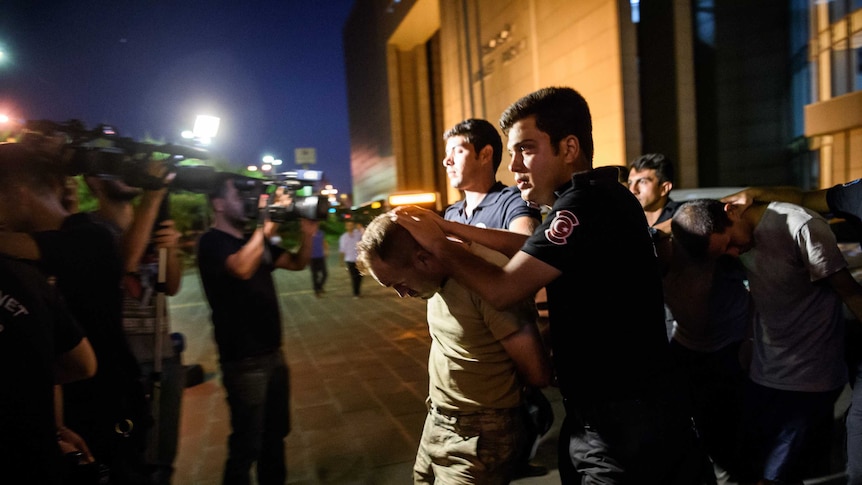 Turkish police escort soldiers allegedly involved in a failed coup from a courthouse in Istanbul
