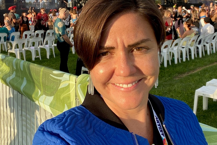 a woman at a music festival smiling