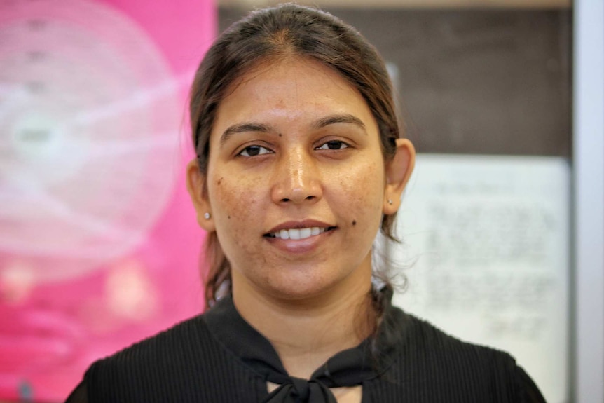 A head and shoulders shot of a young woman posing for a photo.