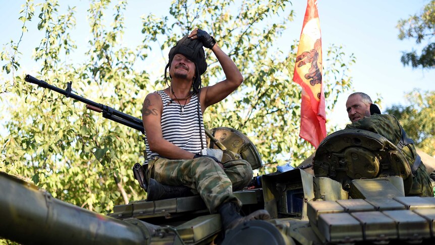 Pro-Russian fighters sitting on a T-64 tank in Starobesheve