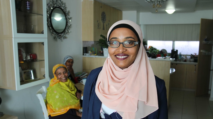 Hadia Komba with her mother and sister in her Flemington public housing flat in Melbourne.