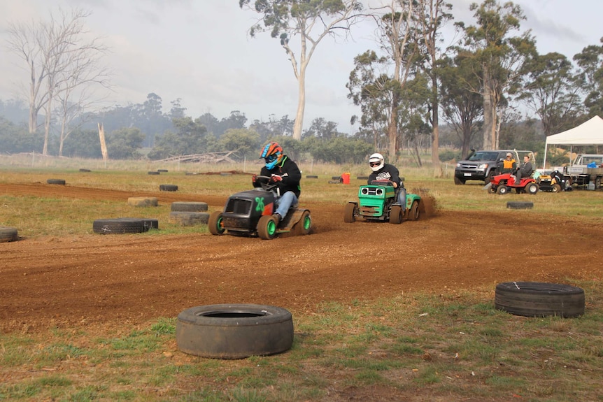 Two lawn mowers racing.