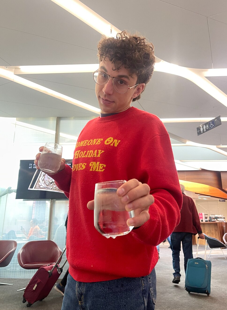 Carmen's boyfriend impersonates Leonardo DiCaprio's old sport face from The Great Gatsby, holding water.