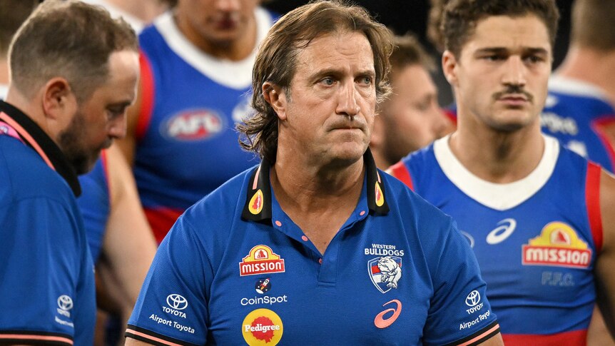 Western Bulldogs head coach Luke Beveridge walks back to the coaches box after speaking to his players