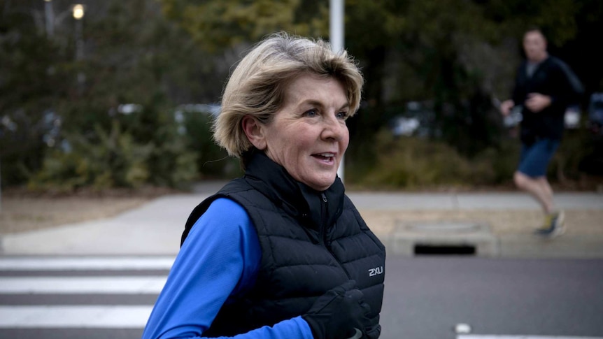Julie Bishop smiles as she completes her morning jog