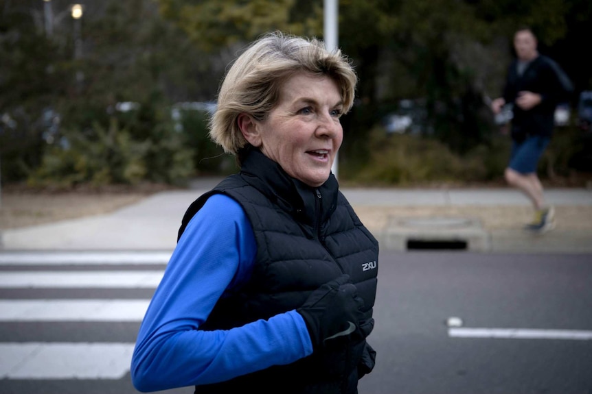 Julie Bishop smiles as she completes her morning jog