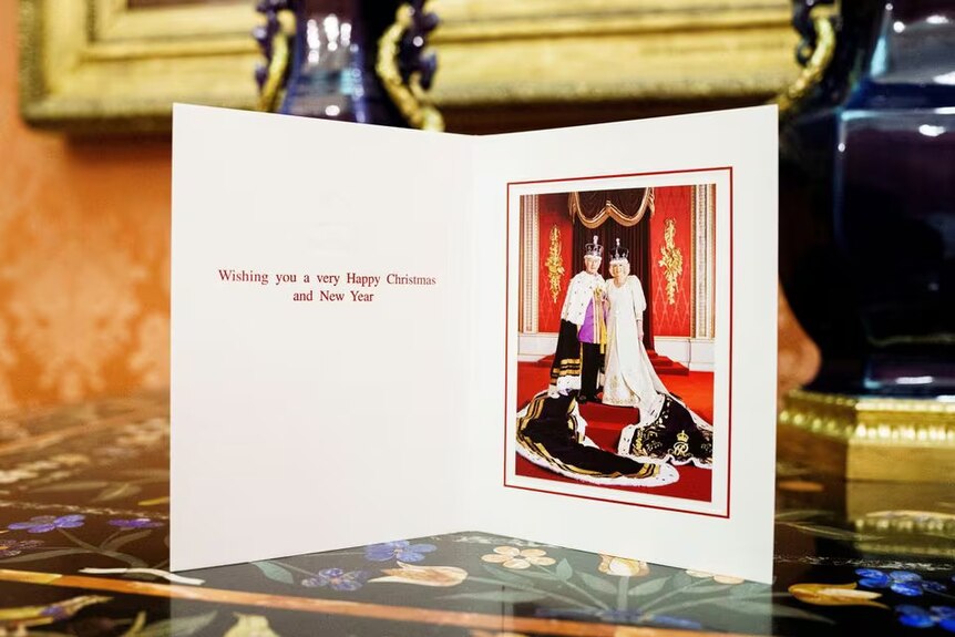 A card with a statement that reads Happy Christmas from King Charles and Queen Camilla
