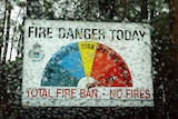 A view of a very high fire danger sign with rain splatters blurring the photo