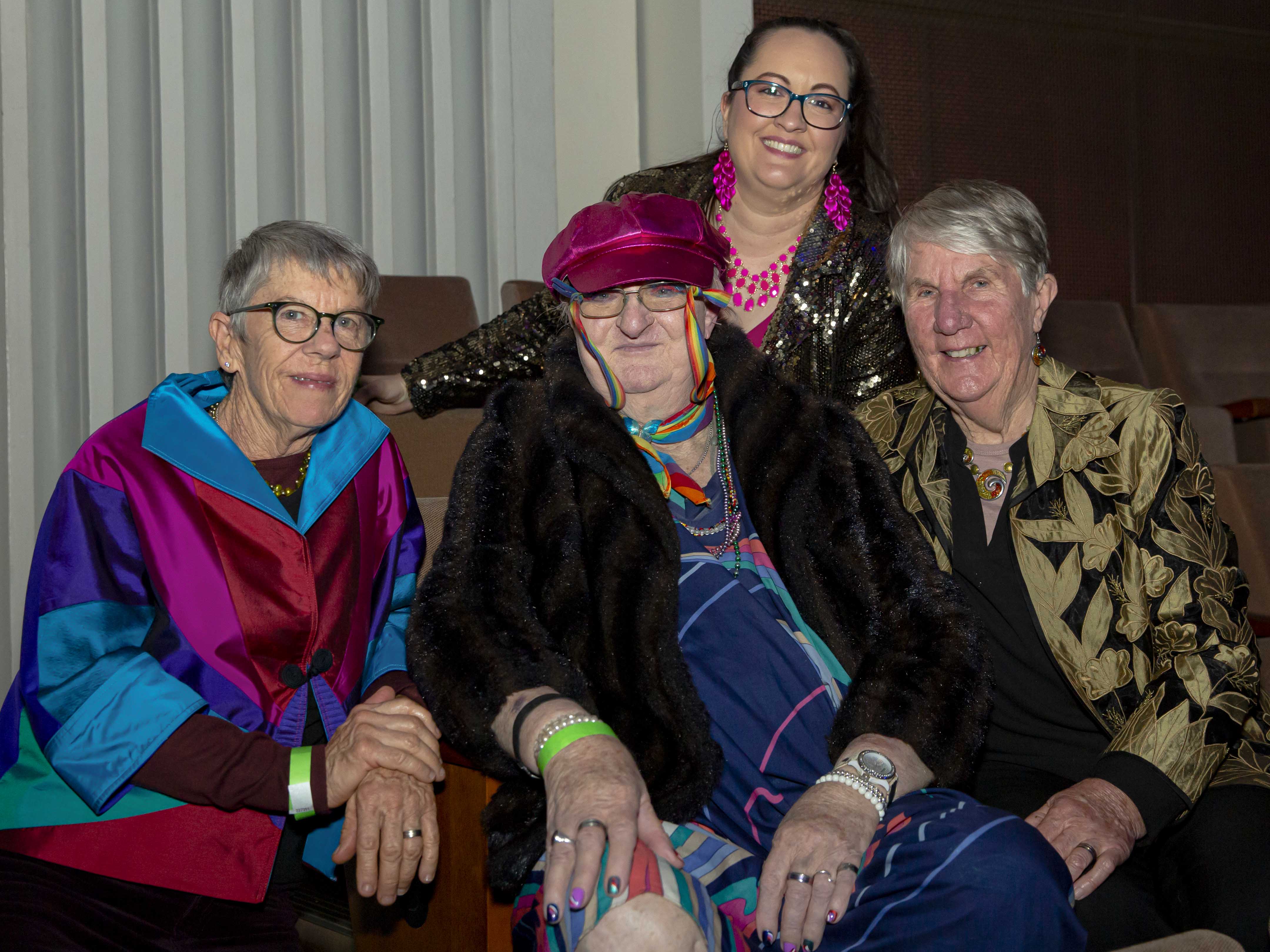 Michelle Rose Turnbull wearing a dress at Queens Ball in Brisbane, surrounded by three supporters