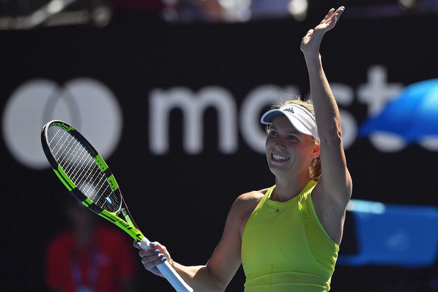 Caroline Wozniacki waves to the Rod Laver Arena crowd after beating Jana Fett at the Australian Open.