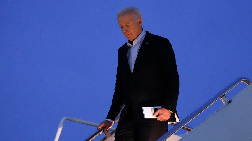 US president Joe Biden descends the steps of Air Force One.