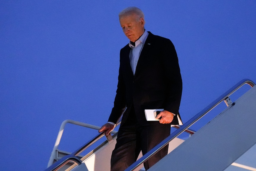 US president Joe Biden descends the steps of Air Force One.