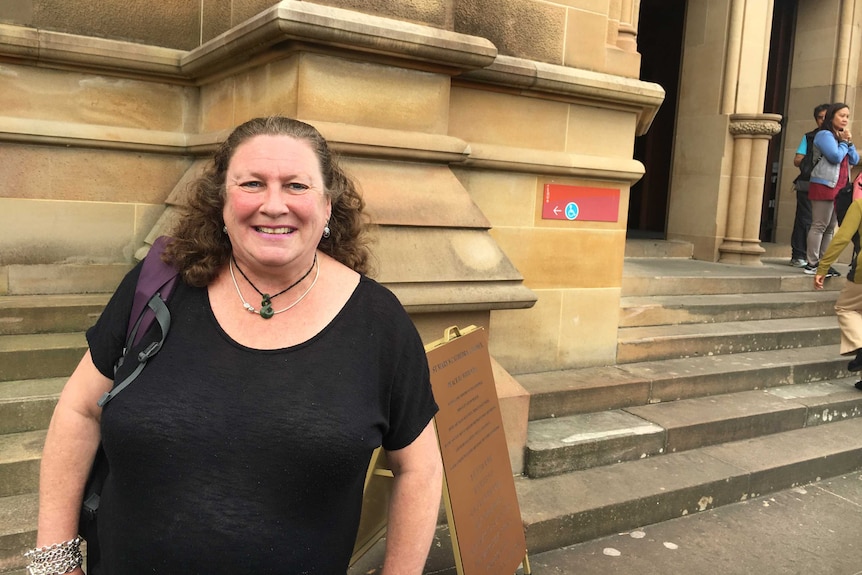 A woman outside a church.