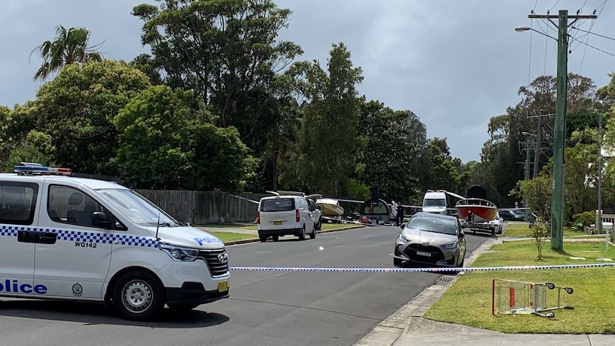 A street with police tape and police cars