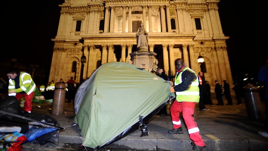 A bailiff removes a tent from the Occupy encampment in front of St Paul's Cathedral.