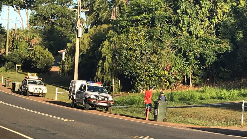 Police talk to people on a street where three skydivers have died in Mission Beach, far north Queensland.