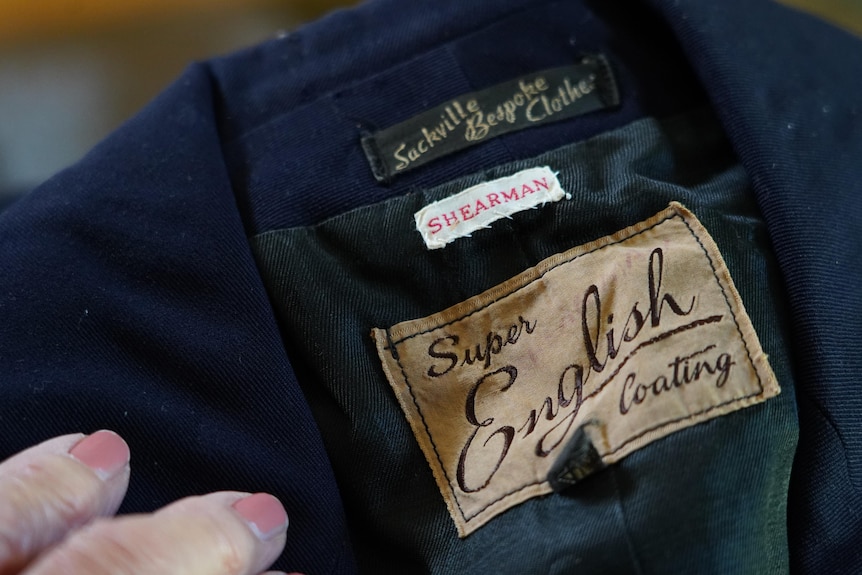 A close up of a jacket label tag which is printed with the name "shearman"