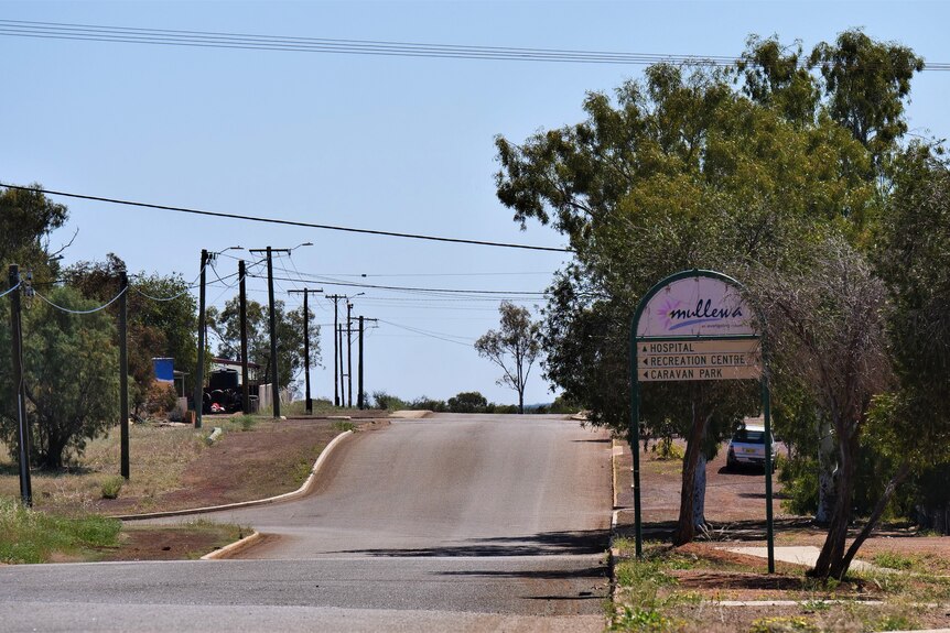 A gently sloping road running through a country town.