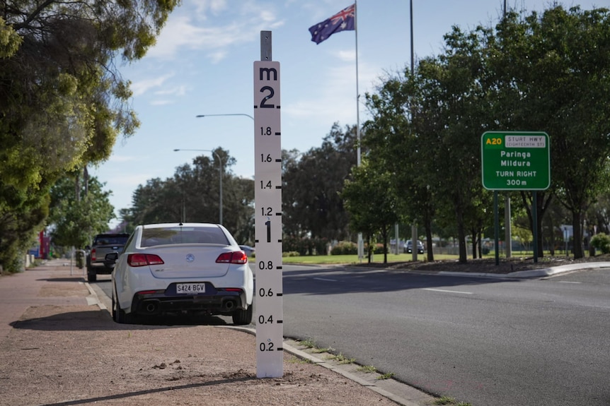 A water level marker on a main road