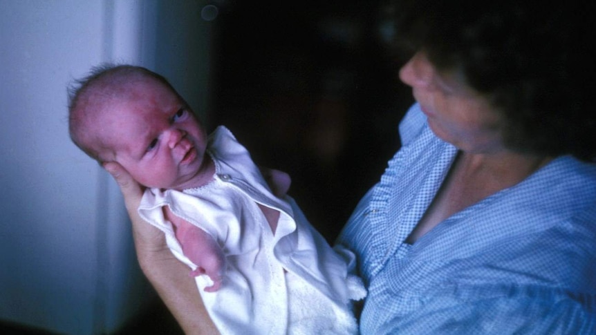 Lisa McManus as a baby being held by her mother.