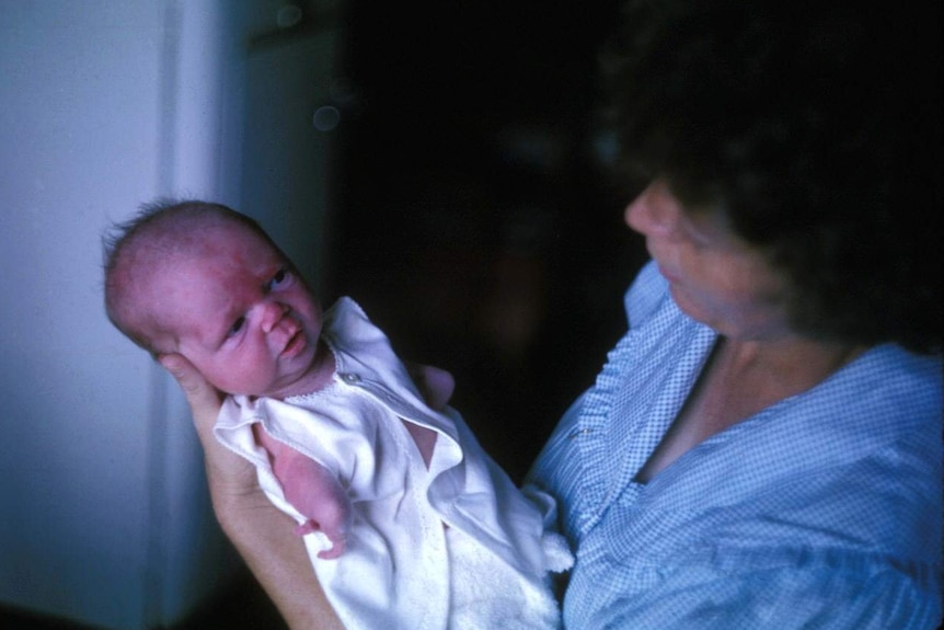 Lisa McManus as a baby being held by her mother.