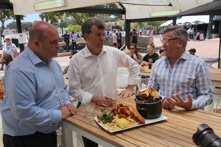 Fisheries Minister Dave Kelly, with AHA chief executive Bradley Woods and a Hillarys restaurant owner.