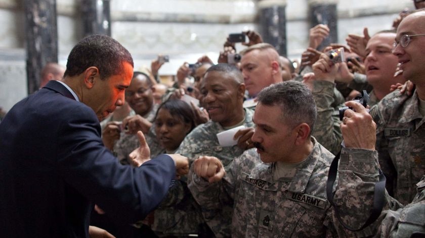 President Obama fist-bumps a US soldier at Camp Victory in Baghdad
