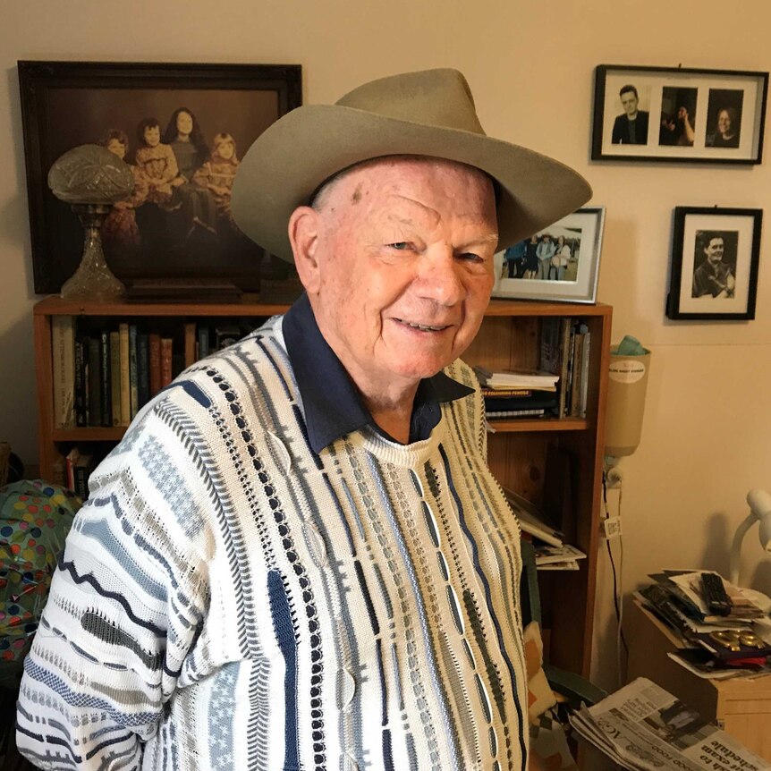 Retired poet Phil Rush standing in his home in Huonville