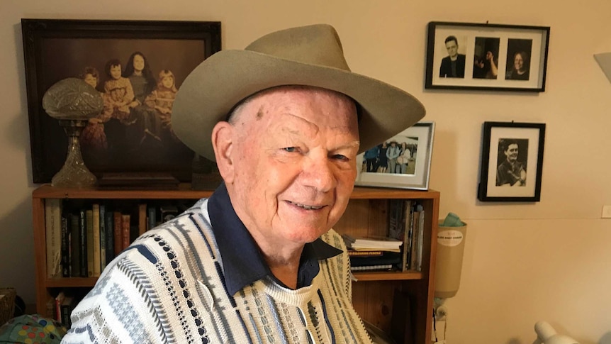 Retired poet Phil Rush standing in his home in Huonville