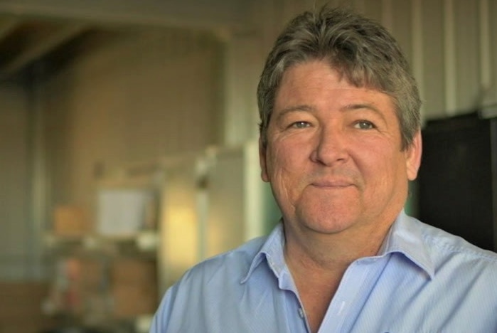 A man stands in a warehouse