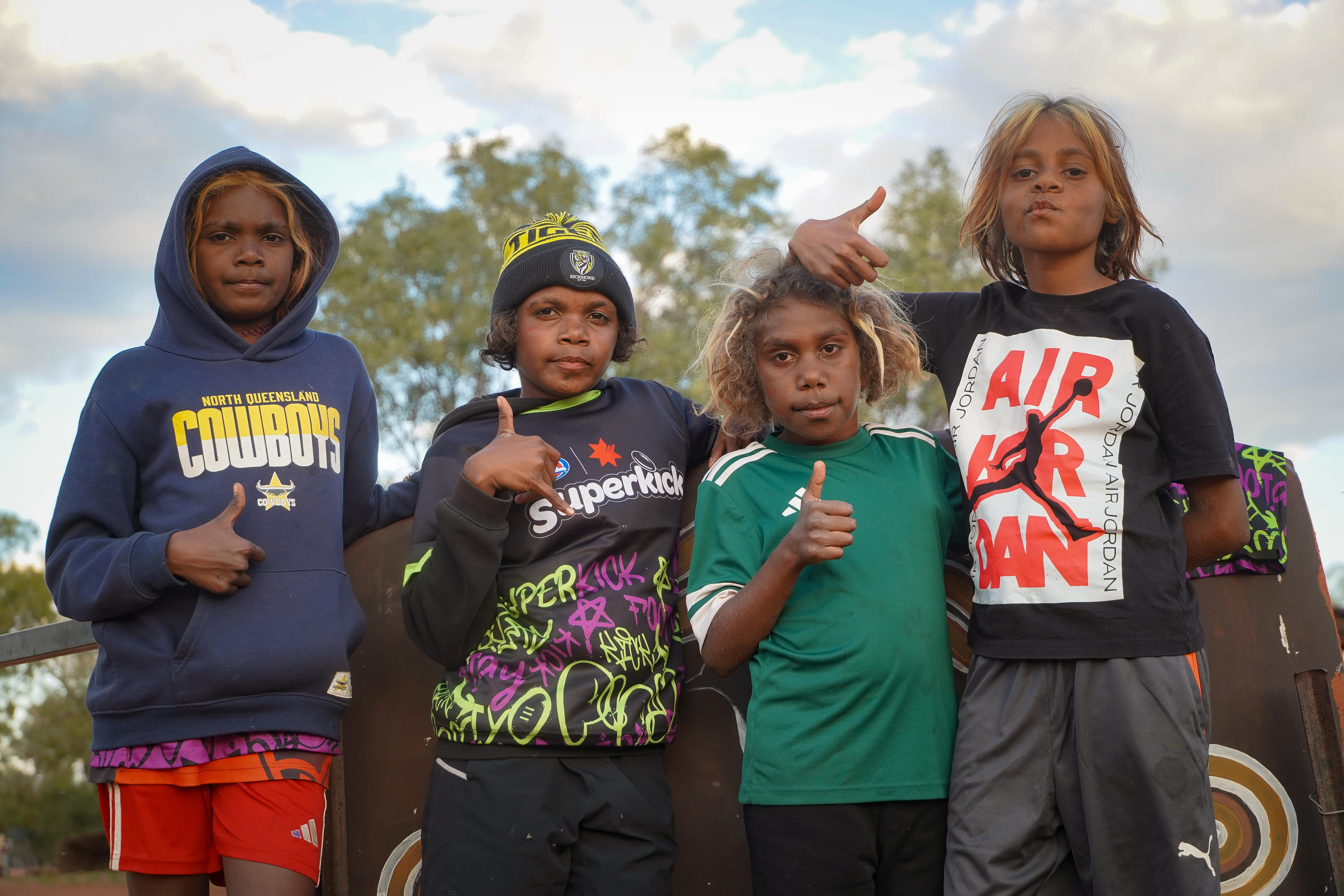 Four young children mug for the camera.