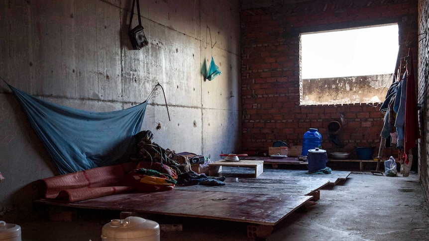 A makeshift living space on the third floor of a high-rise building site.