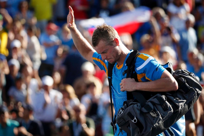 Lleyton Hewitt waves to the crowd after losing to Mikhail Youzhny.