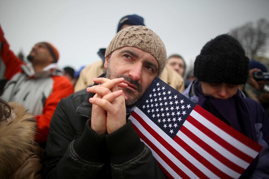 A man watches the inauguration ceremony on Capitol Hill.