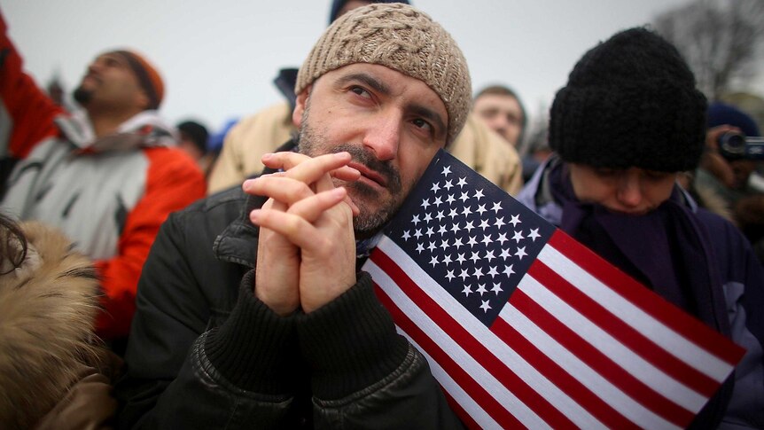 A man watches the inauguration ceremony on Capitol Hill.