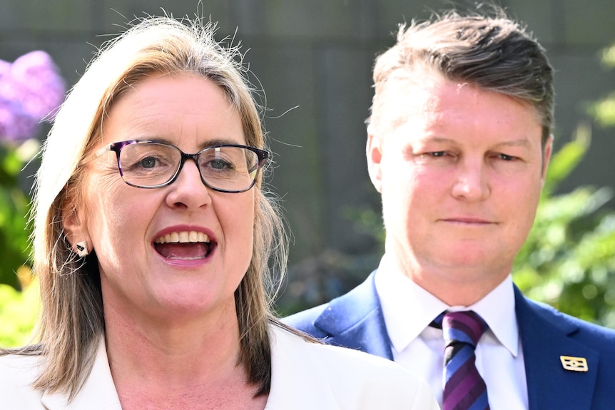 Jacinta Allan flanked by Vicki Ward and Ben Carroll standing in sunshine outdoors.