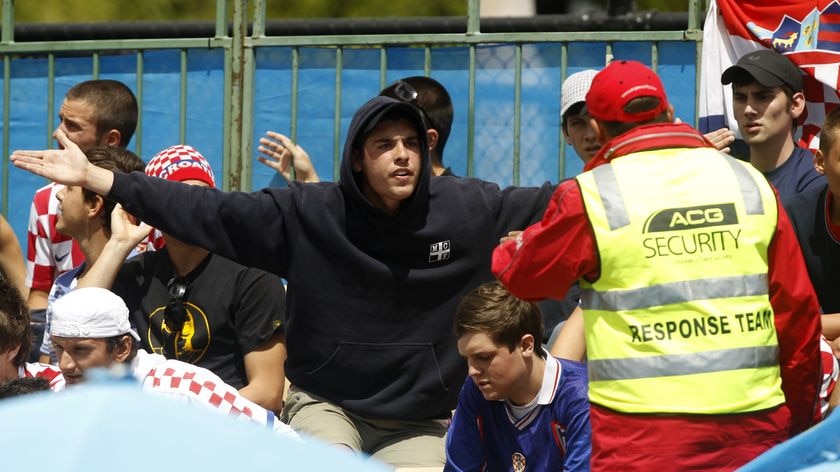 A Croatian fan taunts a security officer before being ejected